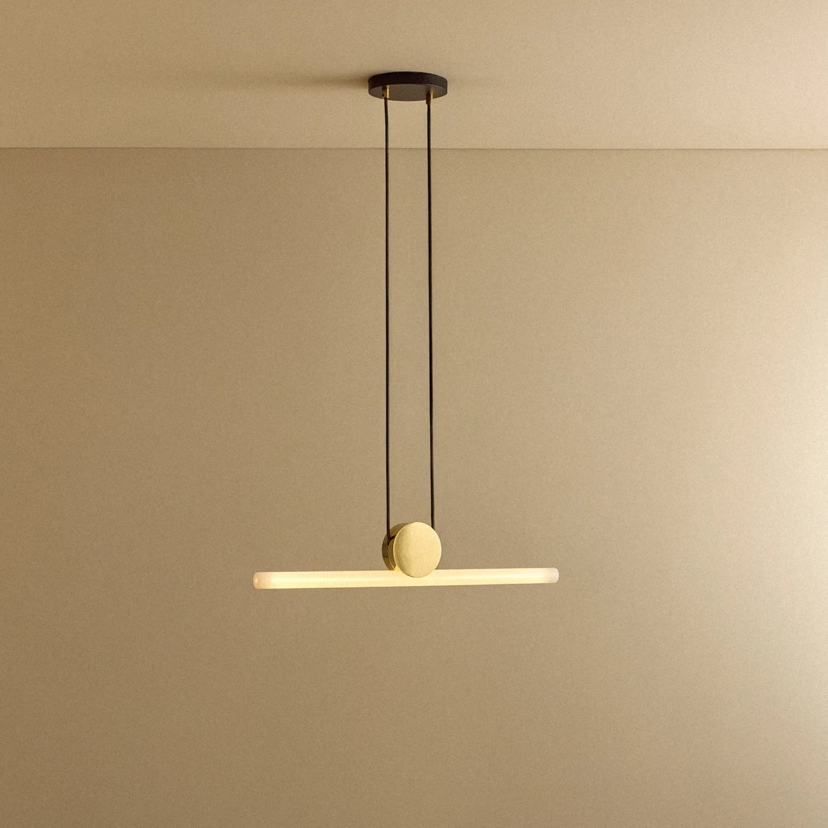 Polished brass linear LED pendant, lit, hanging level