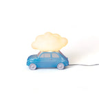Table lamp with a glowing cloud on a small blue car, lit, side view