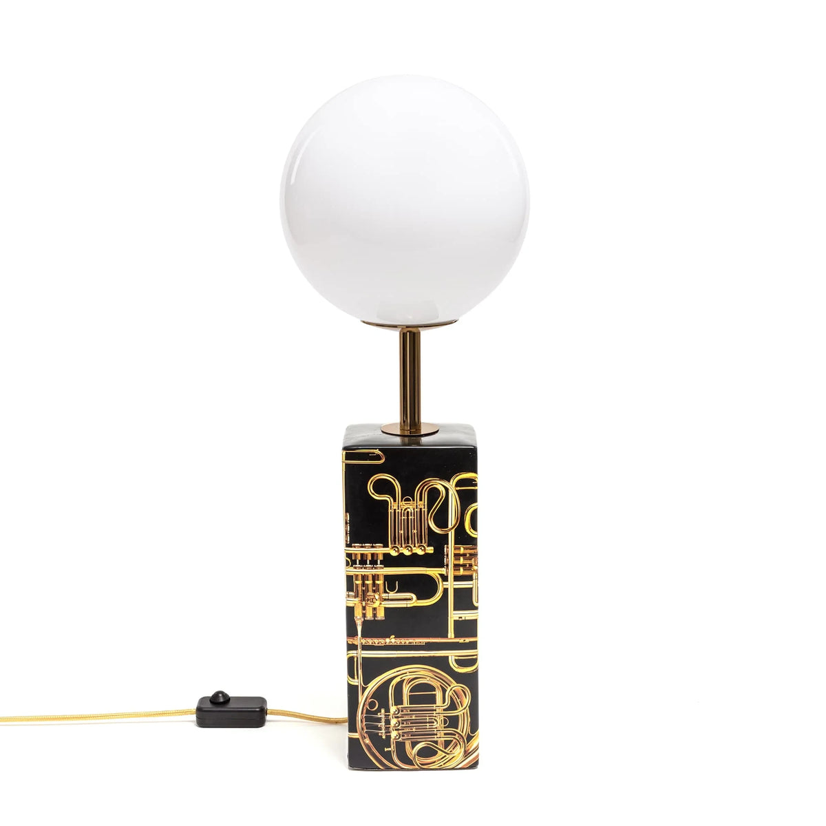Porcelain column table lamp with opal globe and gold trumpet print, on a plain background