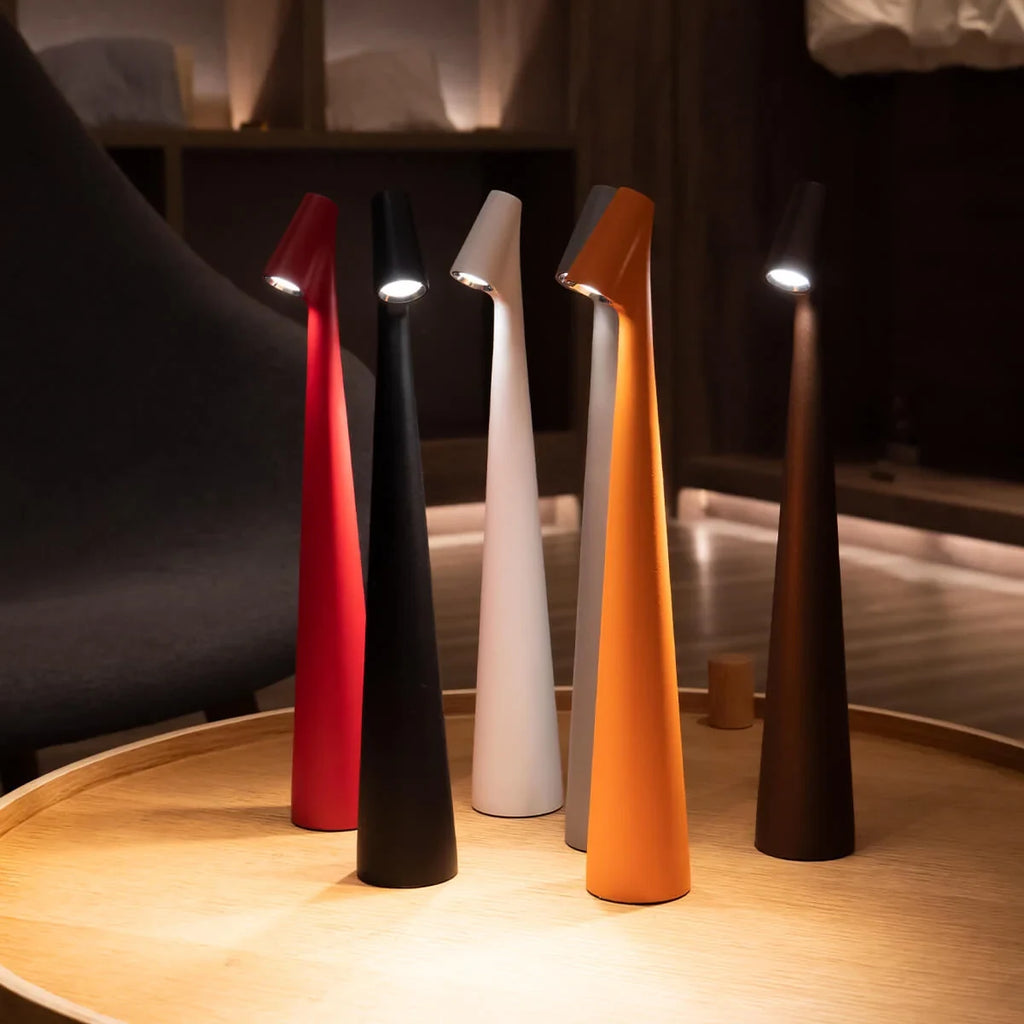 Slim cone cordless table lamp, a group lit in a library