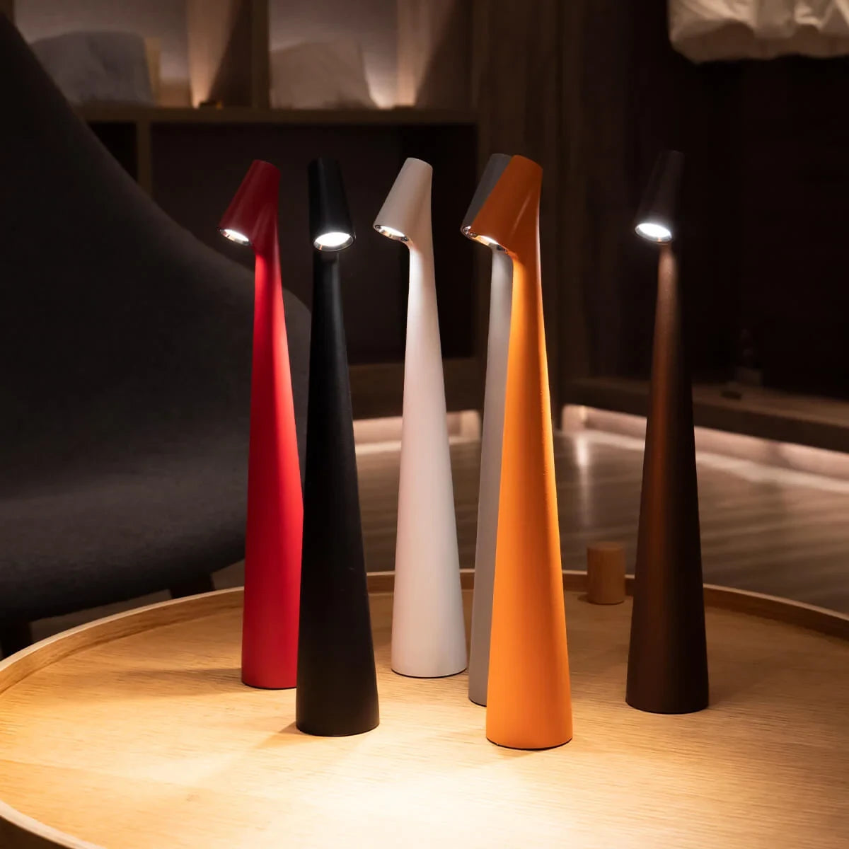 Slim cone cordless table lamp, a group lit in a library