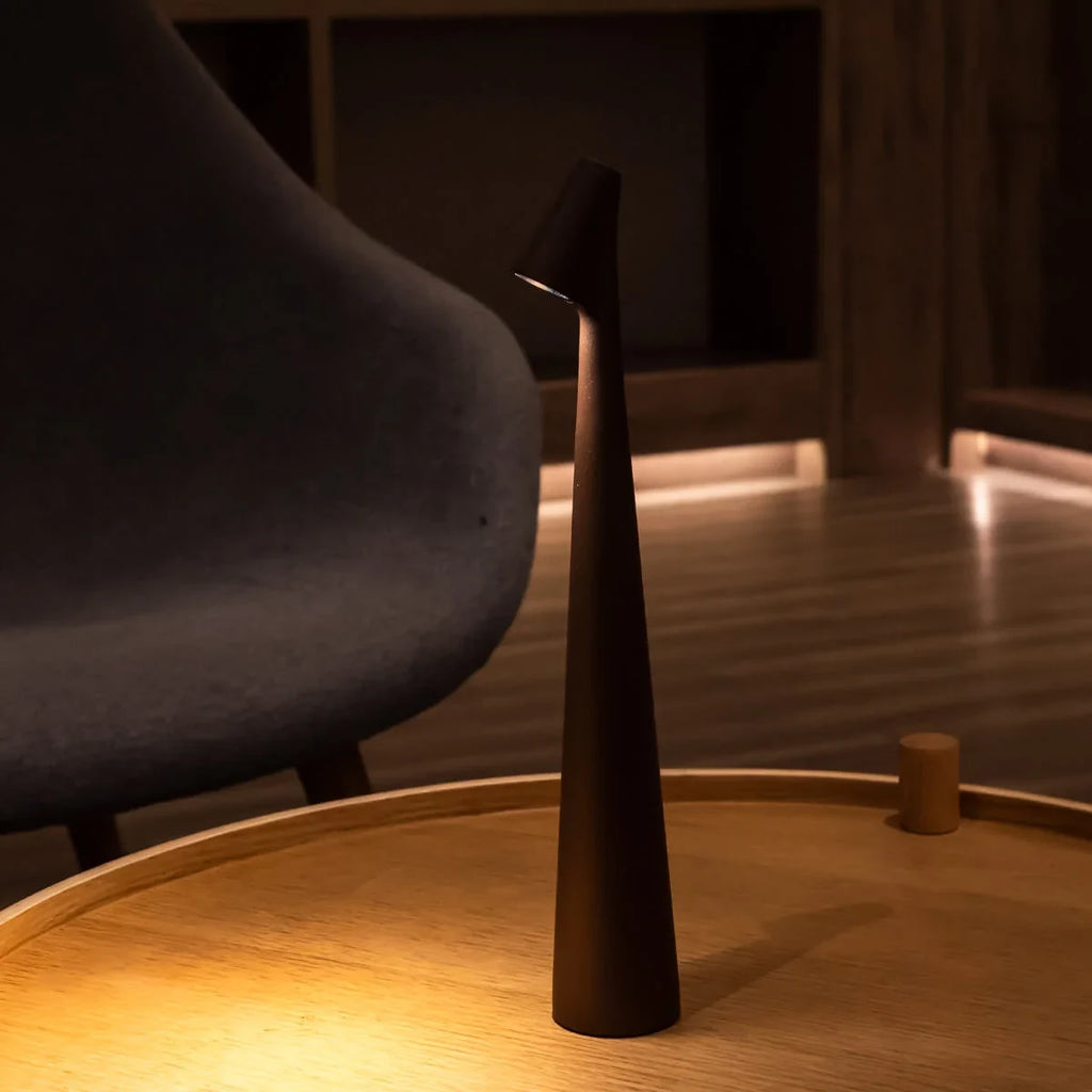 Slim cone cordless table lamp, lit in a living room
