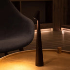 Slim cone cordless table lamp, lit in a living room