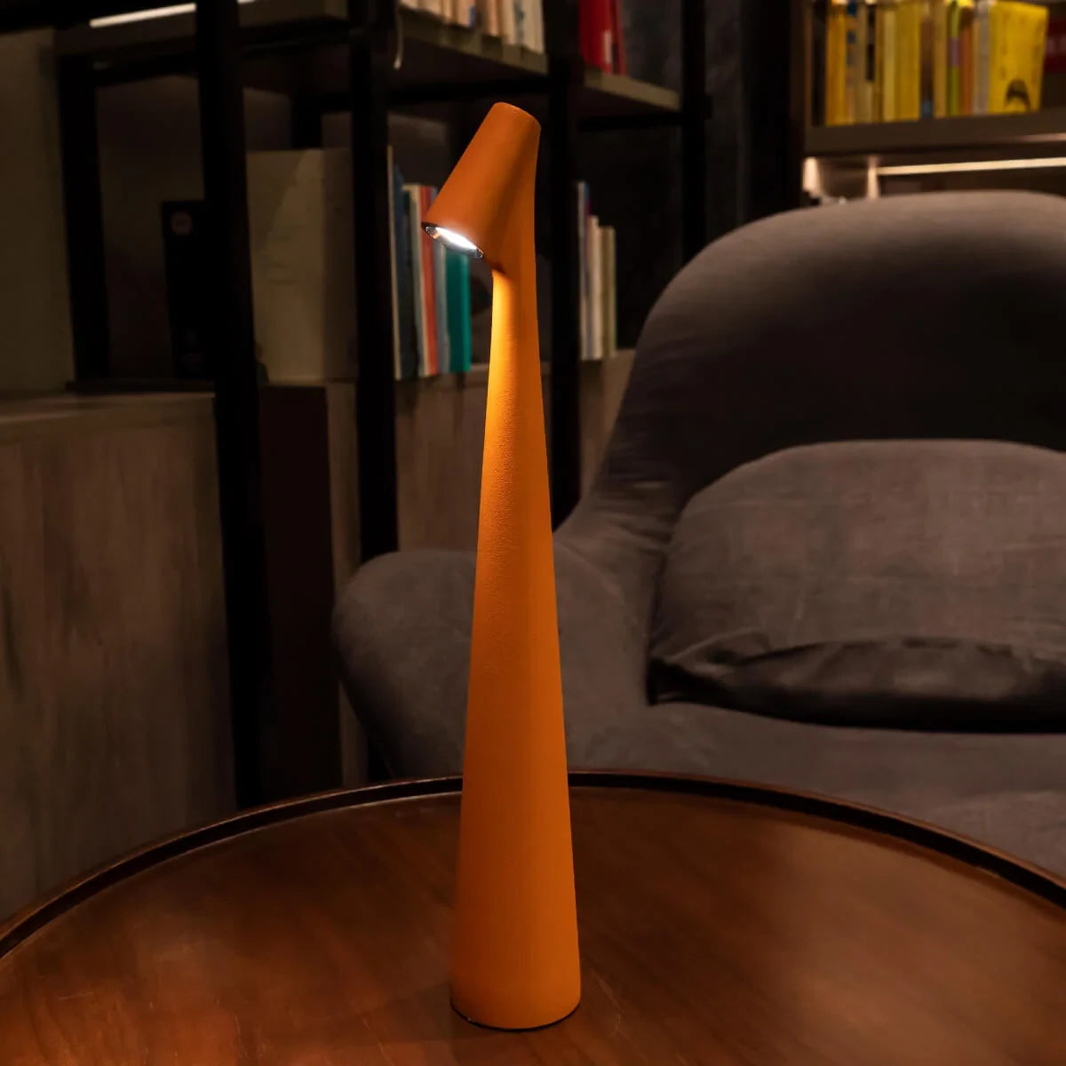 Slim cone cordless table lamp, lit in a living room