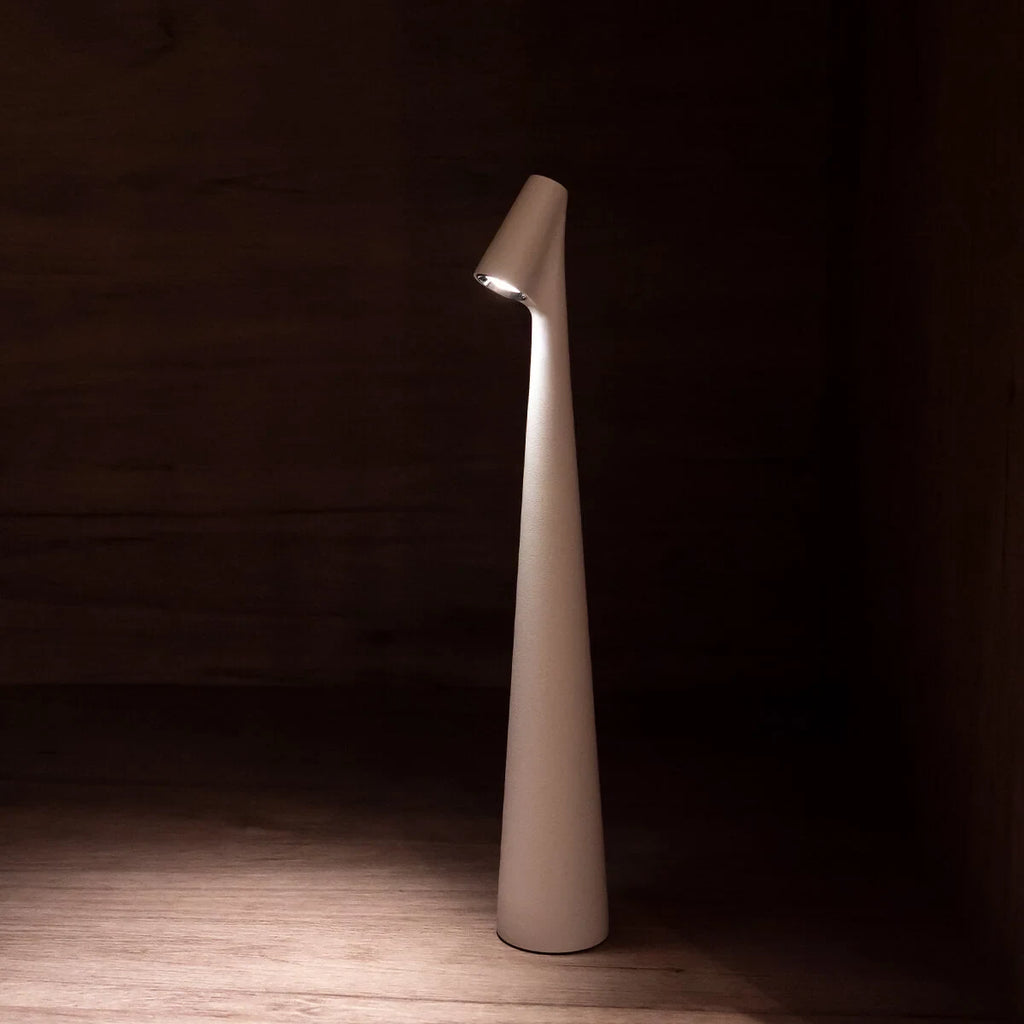 Slim cone cordless table lamp, lit in a living room