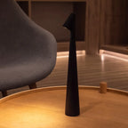Slim cone cordless table lamp, lit in a living room