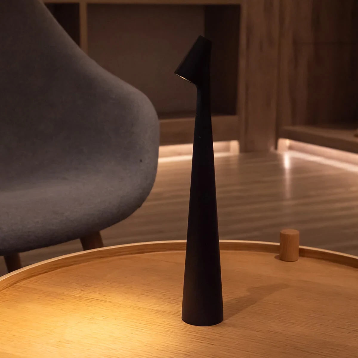 Slim cone cordless table lamp, lit in a living room