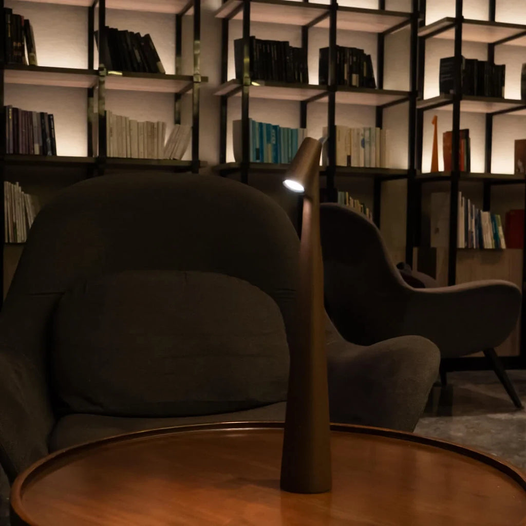 Slim cone cordless table lamp, lit in a living room