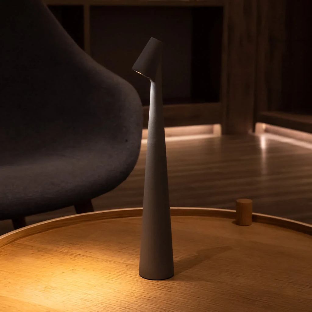 Slim cone cordless table lamp, lit in a living room