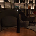 Slim cone cordless table lamp, lit in a living room