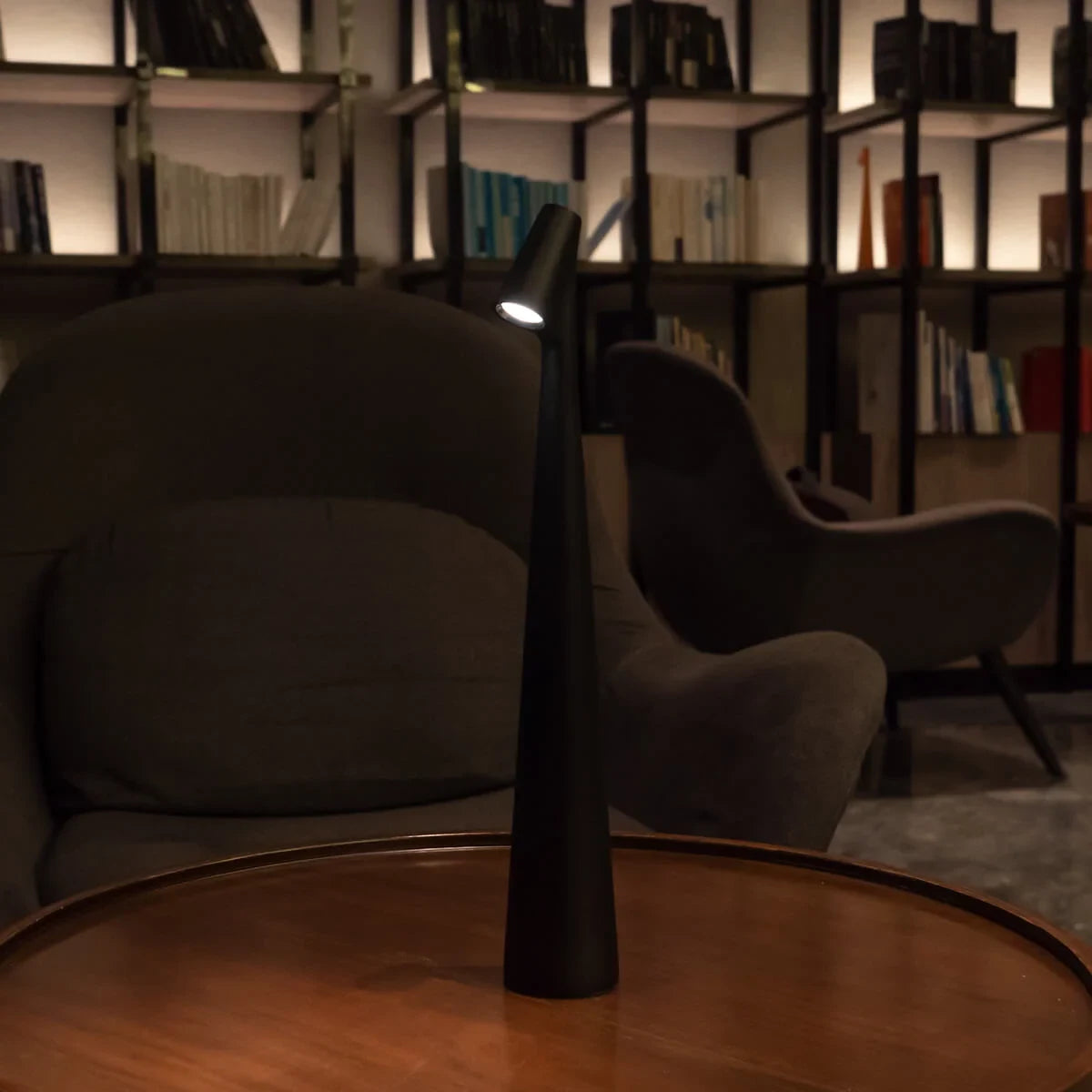 Slim cone cordless table lamp, lit in a living room
