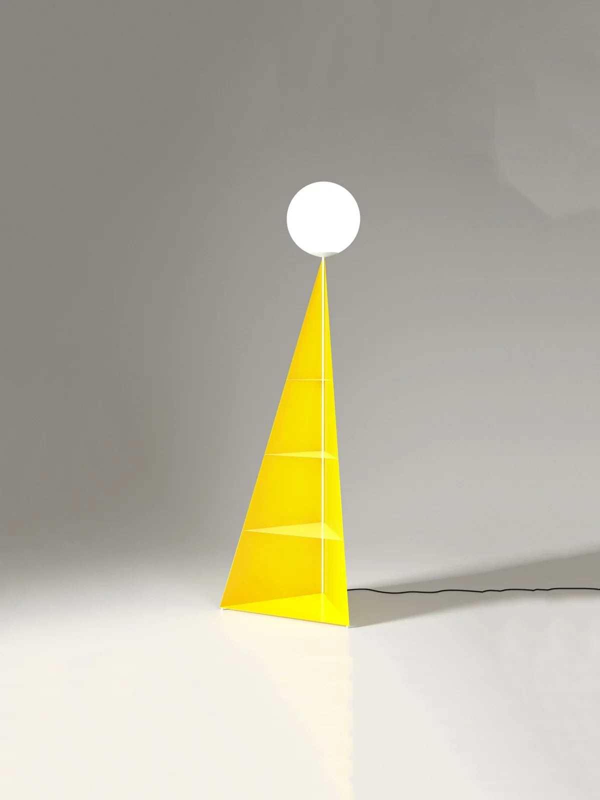 Pyramid base floor lamp with a white glass globe, in yellow against a plain wall