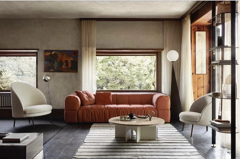 Pyramid base floor lamp with a white glass globe, in a living room beside a sofa