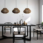 Woven rattan pendant light, three above a dining table