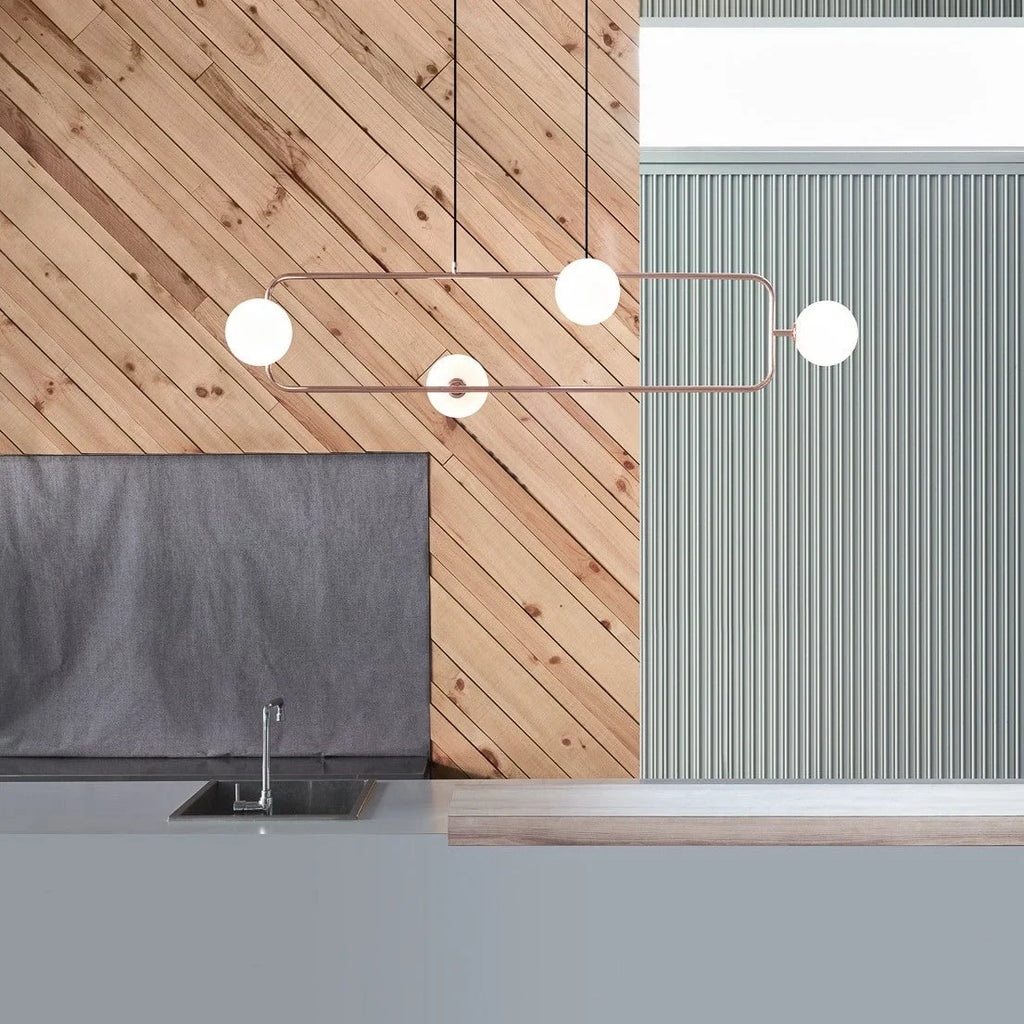 Rectangular Frame Four-Globe Linear Pendant, above a kitchen worktop, globes turned