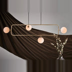 Rectangular Frame Four-Globe Linear Pendant, in champagne gold with globes turned out