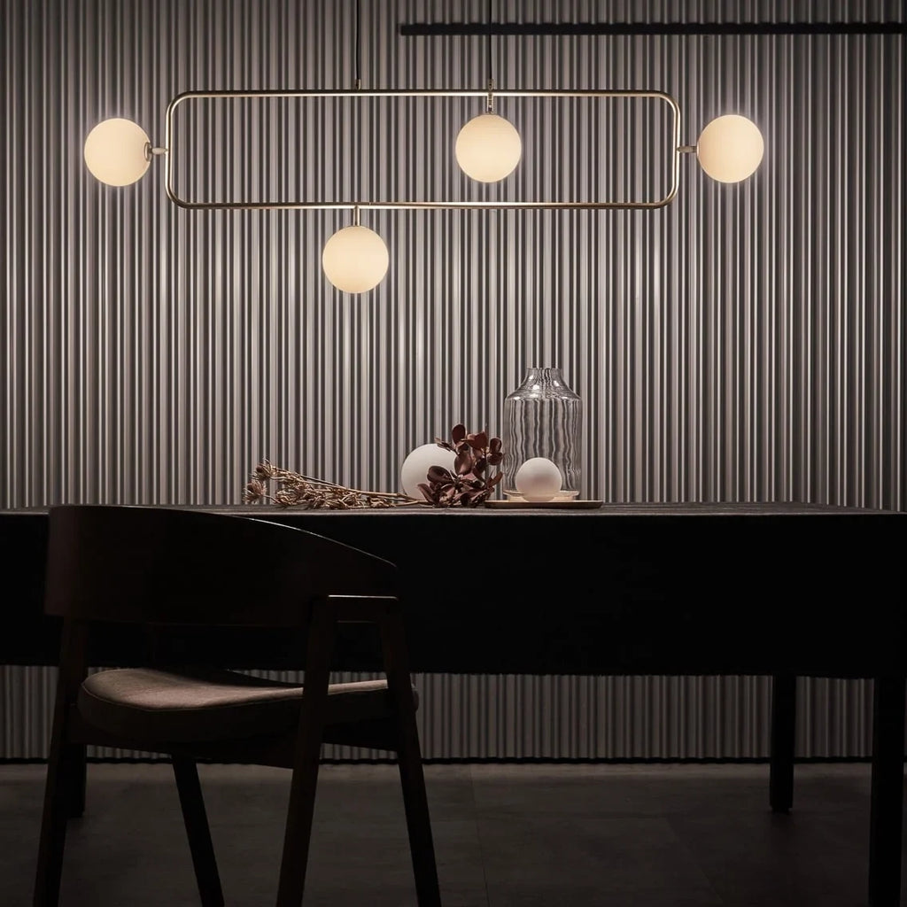 Rectangular Frame Four-Globe Linear Pendant, above a dining table
