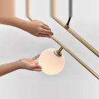 Rectangular Frame Four-Globe Linear Pendant, globe being turned by hand