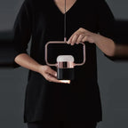 Rectangular frame LED pendant, held in two hands
