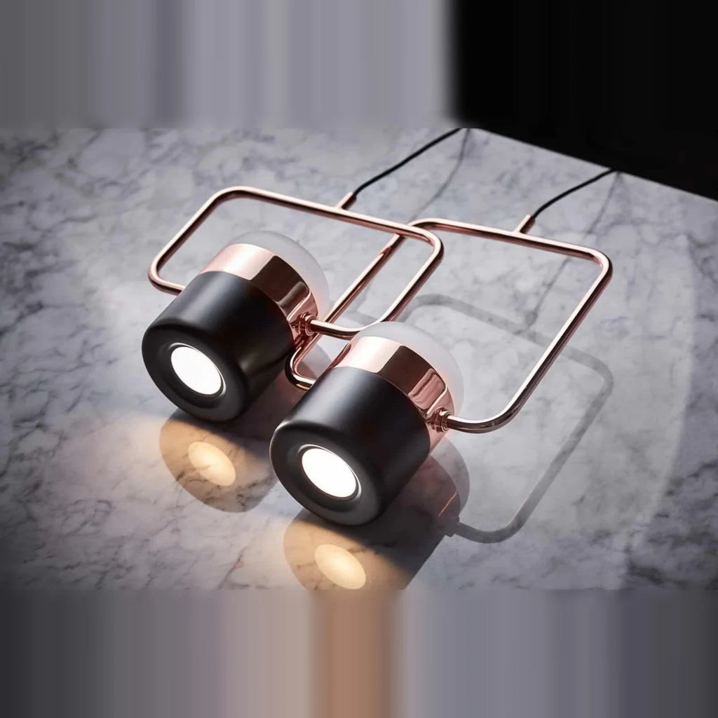 Rectangular frame LED pendant, portrait, pair lying on a marble surface, lit