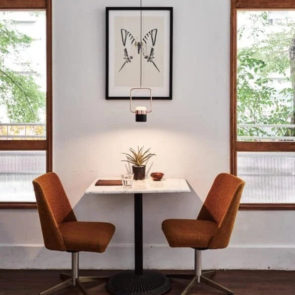 Rectangular frame LED pendant, portrait, above a small dining table