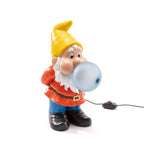 Resin dwarf table lamp blowing a glowing glass bubble, front view, unlit