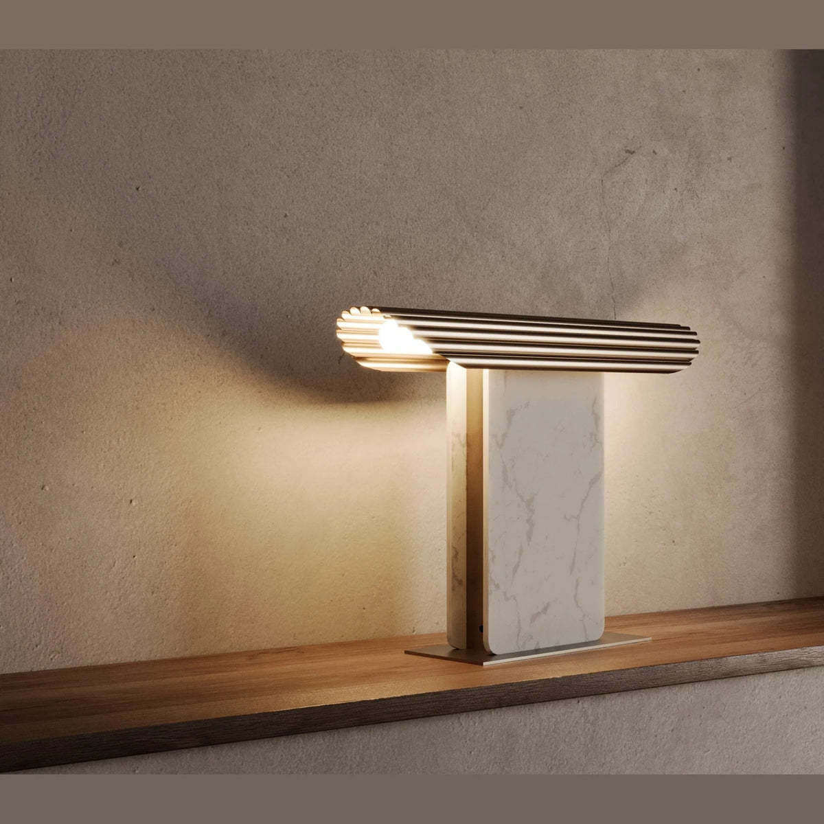 Ribbed head table lamp on marble column, lit, on a wooden shelf