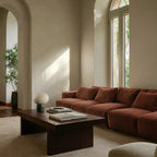 Ribbed opal glass globe table lamp, in a living room, in front of a red sofa
