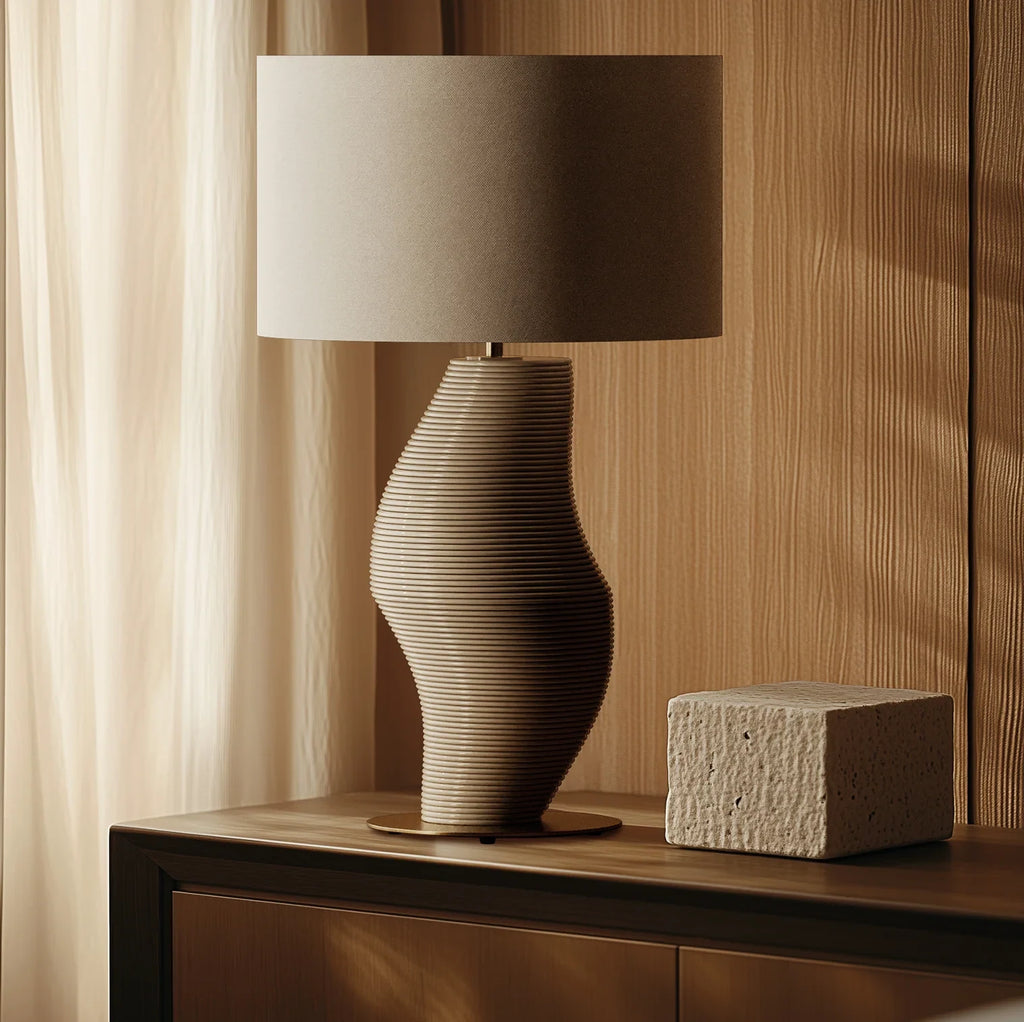 Ribbed sculptural glass table lamp, beside a wooden wall, with a shade (not included)