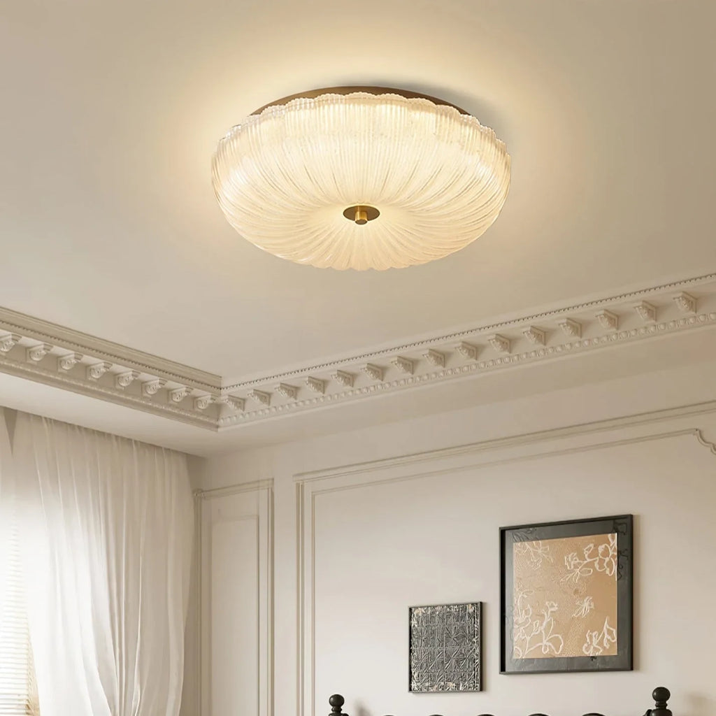 Ripple glass flush ceiling light, lit in a bedroom