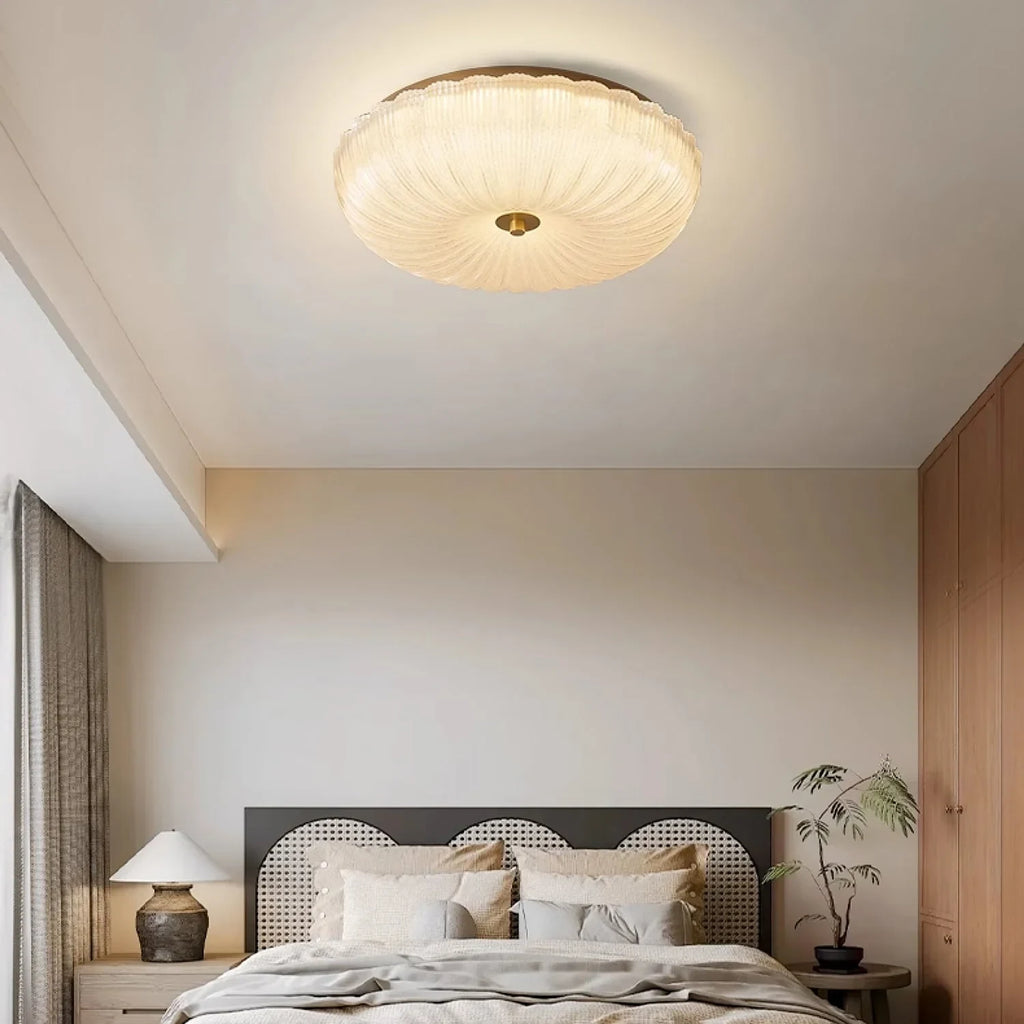 Ripple glass flush ceiling light, lit in a bedroom