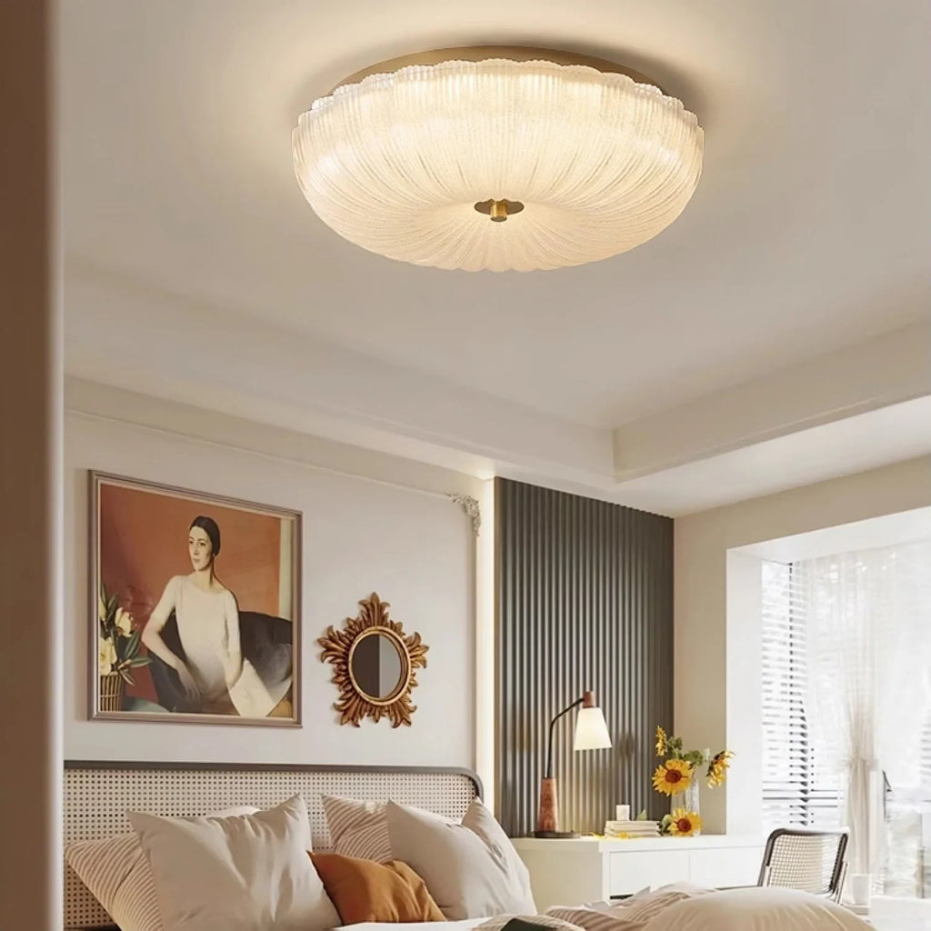 Ripple glass flush ceiling light, lit in a bedroom