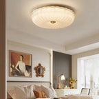 Ripple glass flush ceiling light, lit in a bedroom