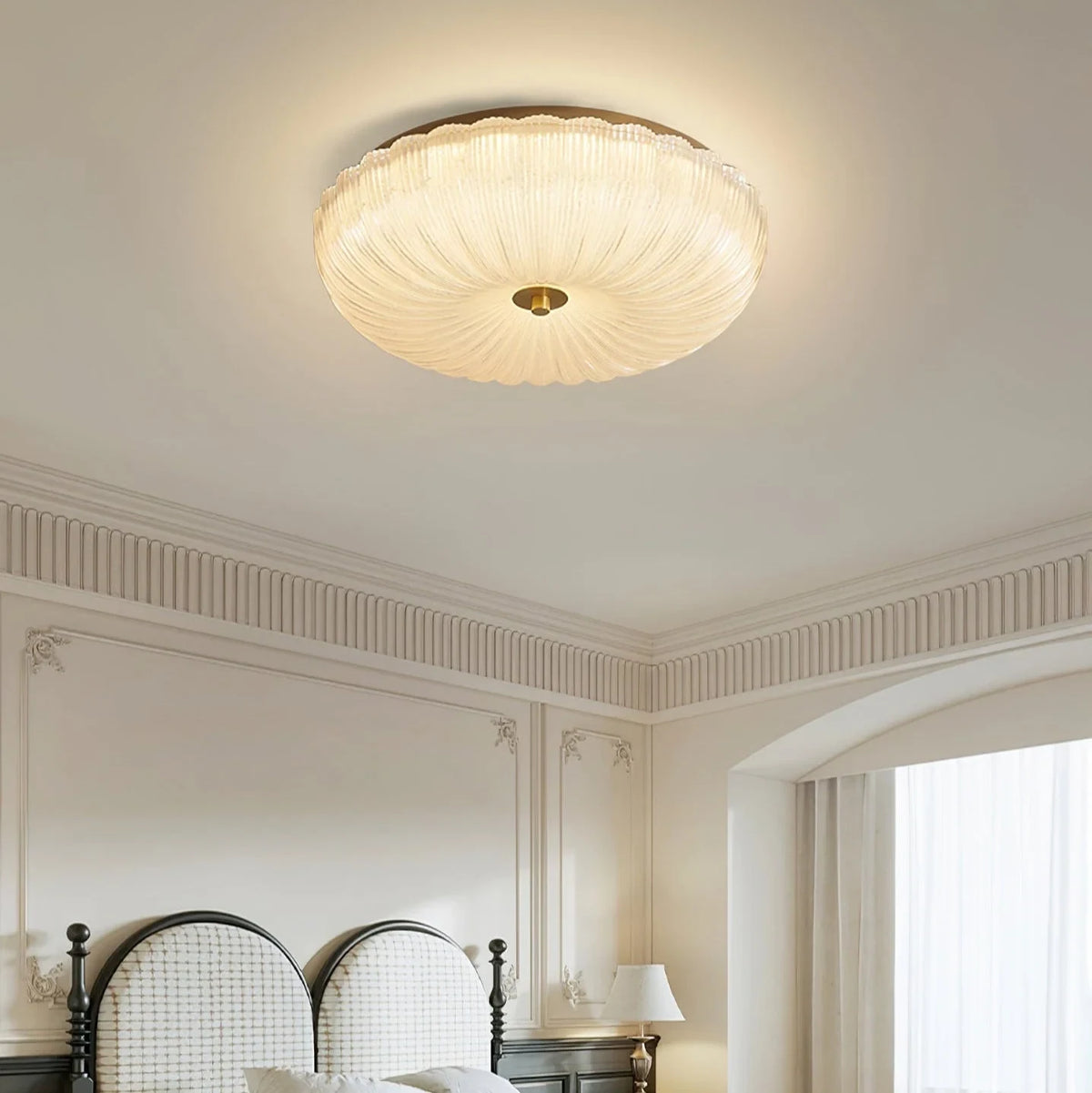 Ripple glass flush ceiling light, lit in a bedroom