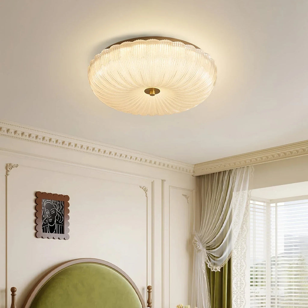 Ripple glass flush ceiling light, lit in a bedroom