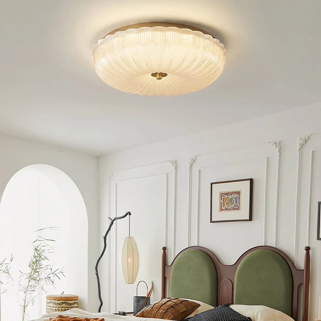 Ripple glass flush ceiling light, lit in a bedroom