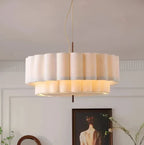 Layered ripple pendant light in white, lit, close up