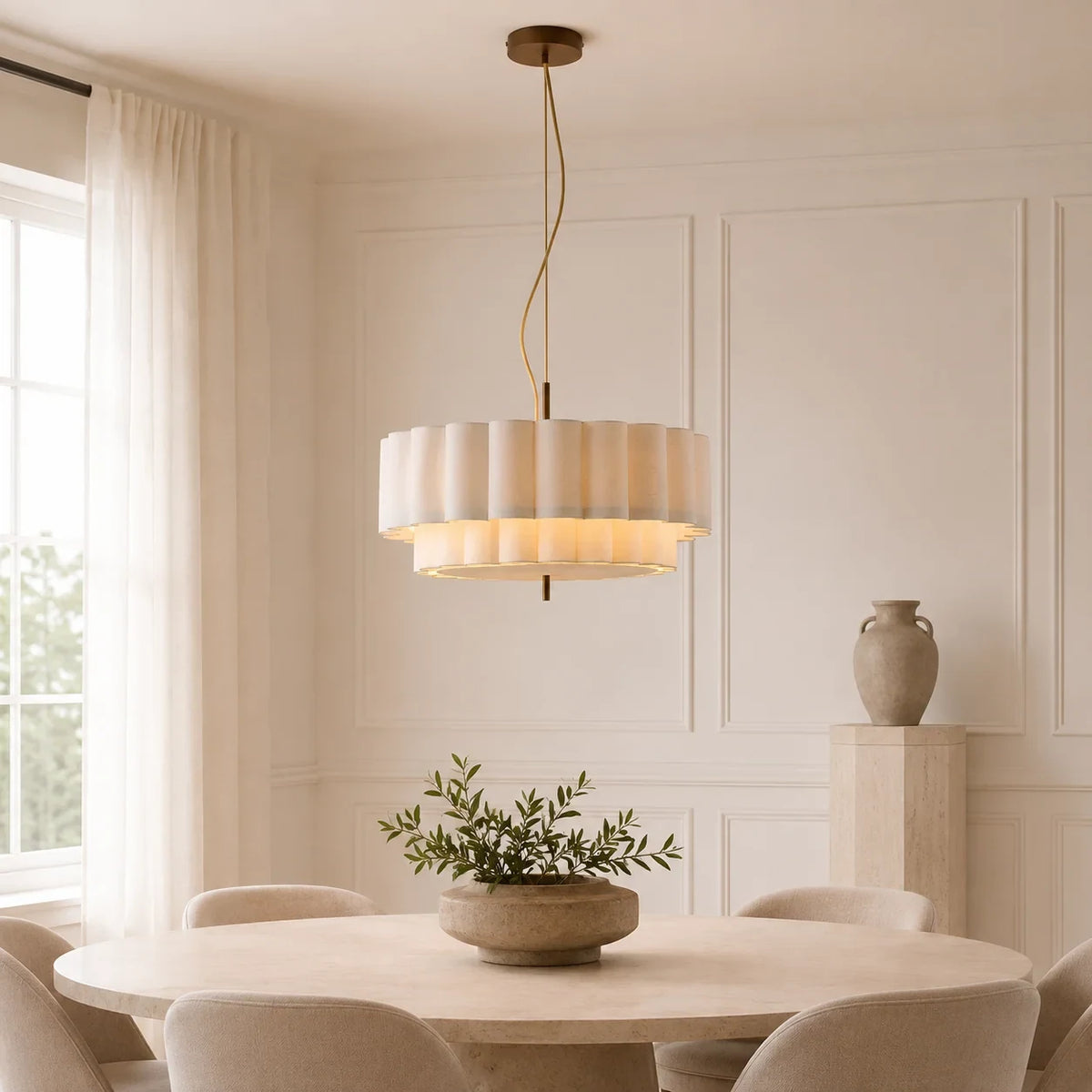 Layered ripple pendant light in white, above a dining table