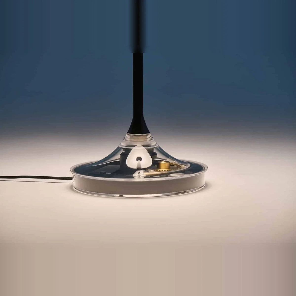 Black disc table lamp with rotating dimmer base, close-up of the base