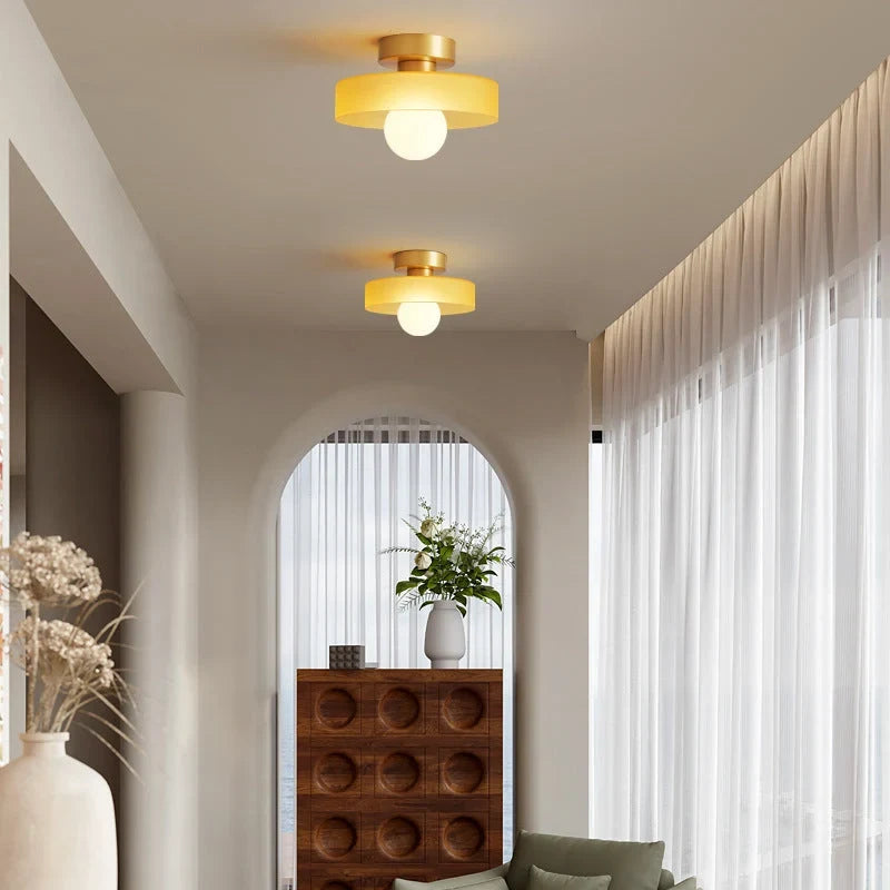 Round glass flush ceiling light, two with gold bases in a hallway