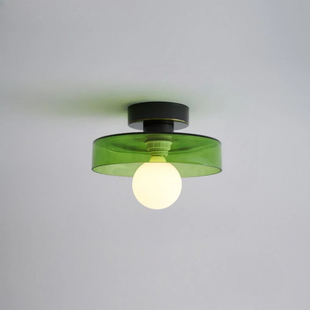 Round glass flush ceiling light, with a black base and green glass