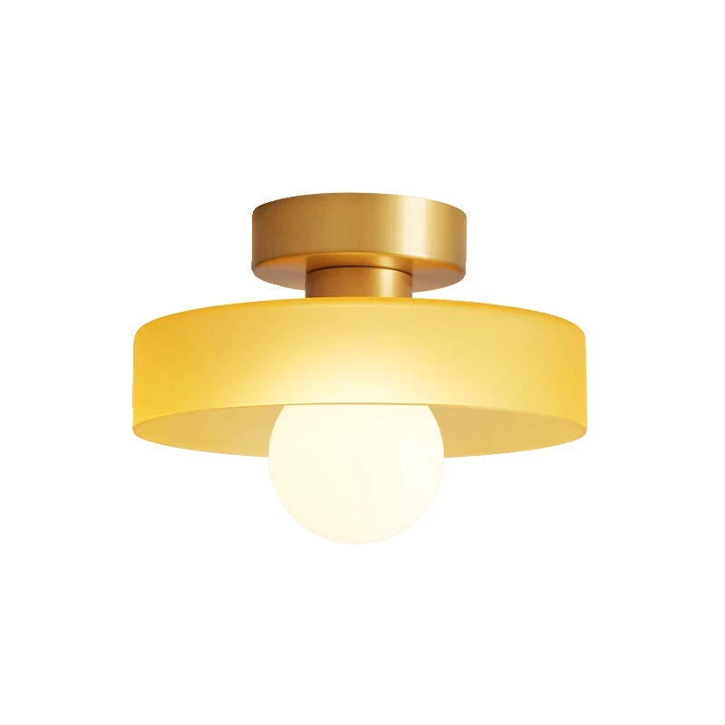 Round glass flush ceiling light, with a gold base and orange glass, cut-out