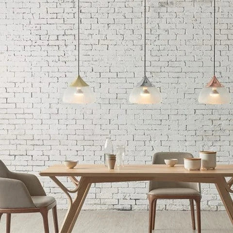 Sandblasted glass pendant, in all three finishes above a dining table