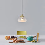 Sandblasted glass pendant, in champagne gold above a kitchen table