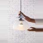 Sandblasted glass pendant, in chrome, held in two hands