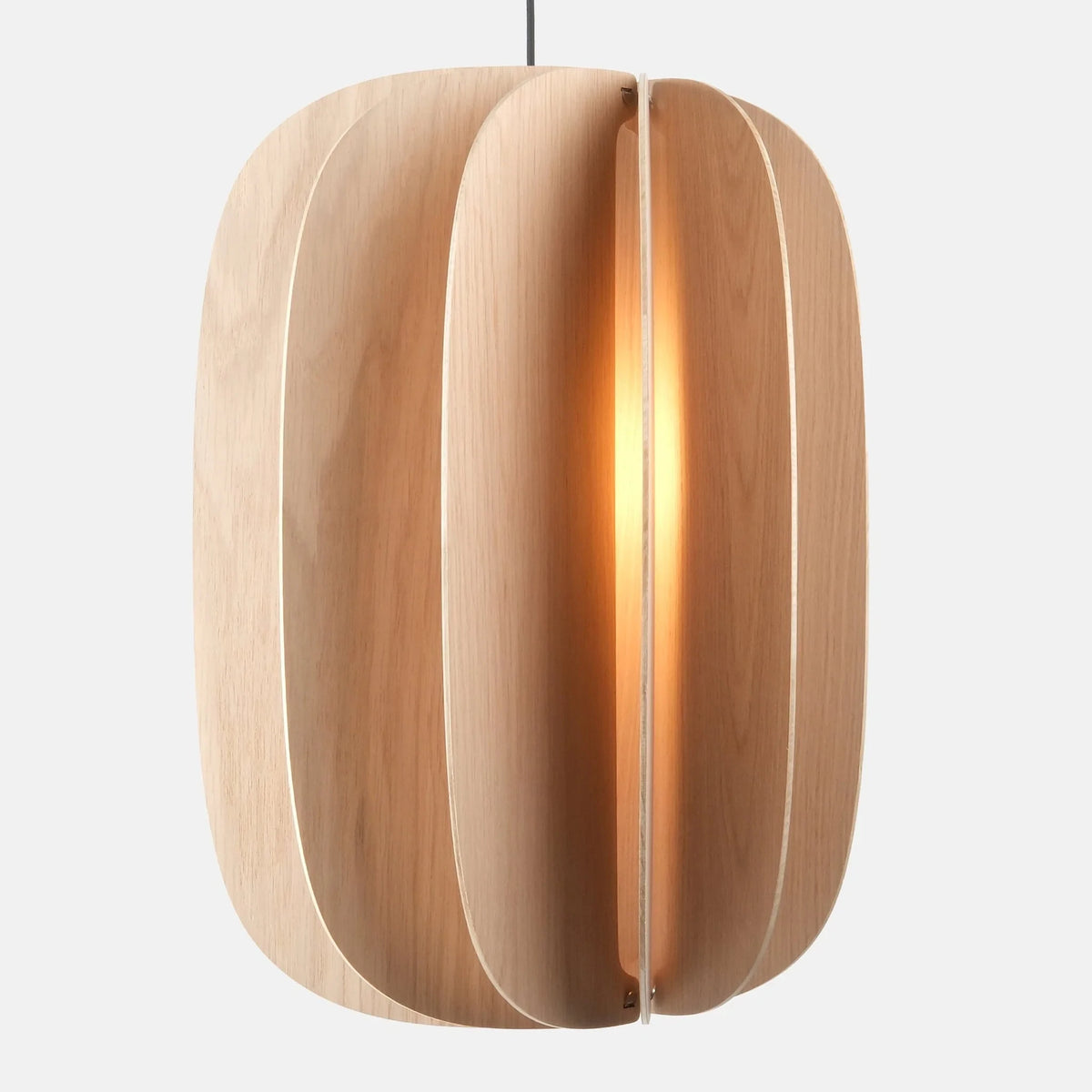 Sculptural white oak pendant, lit, on a plain background