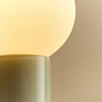 Mouth-blown glass table lamp in sea green, close-up of the glass base and bulb