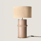 Segmented ceramic column table lamp, in taupe, with a linen shade (not included)