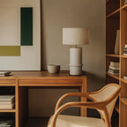 Segmented ceramic column table lamp, on a desk, with a shade (not included)