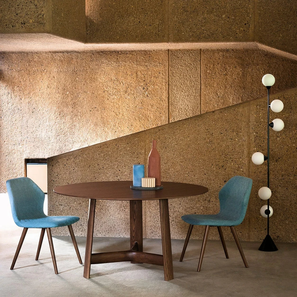 Six-globe vertical opal glass floor lamp, in black beside a dining table